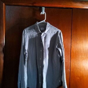 IM SELLING A STRIPPED BUTTON DOWN SHIRT